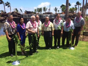 State officials and dignitaries untie the maile lei for the Kahului Airport Access Road blessing ceremony. From left to right: Ross Higashi, Deputy Director, HDOT Airports Division; Leah Belmonte, Governor Ige’s Maui Representative; Joseph Souki, House of Representatives; Marvin Moniz, Maui Airports District Manager; Gilbert Keith-Agaran, State Senator; Kalani English, State Senator; Alan Arakawa, Maui County Mayor; Gerry Majkut, Hawaiian Dredging Construction Company. 