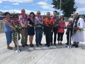 Gov. David Ige, area residents and legislators, representatives from the Federal Highways project team, and Kahu Kordell Kekoa gather to bless the new Halona Street Bridge. From Left to Right: Nida Laganse; Nieves Joaquin; Ralph Rizzo, Federal Highway Administration (FHWA) Hawaii Division Administrator; Sen. Donna Mercado Kim; Dusty Escamilla, FHWA Regional Engineer; Gov. David Ige; Rep. Takushi Ohno; Jane Higa; Florence Higa; Kahu Kordell Kekoa