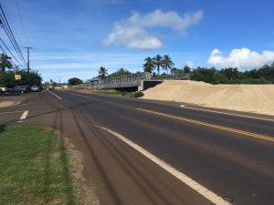 A temporary bridge is being built adjacent to the current bridge to allow vehicles to continue on Kaumualii Highway (Route 50) without impacting construction efforts.
