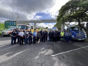 Photo of crash responders standing in front of their vehicles.