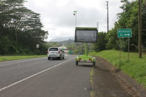 The message board on Kamehameha Highway near the Hawaiian Memorial Park Cemetery will provide Honolulu bound travelers with Pali Highway travel times which will help determine if it is better to take the H-3 Freeway (the message is not displayed in the photograph). Photo courtesy “HDOT” or “Hawaii Department of Transportation”