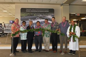 Airlines Committee of Hawaii Co-Chair Blaine Miyasato (from left to right), House Vice Speaker Mark Nakashima, Governor David Ige, HDOT Director Jade Butay, Senate President Ronald Kouchi, Hawaiian Airlines President &amp; CEO Peter Ingram, Hensel Phelps Vice President Thomas Diersbock, and Kahu Kordell Kekoa participate in the untying of the maile lei during the groundbreaking ceremony for the Mauka Concourse project.