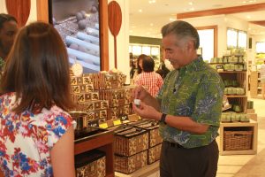 Governor David Ige samples some of the local products featured at the From Hawaii with Love shop in the newly renovated Central Concourse at HNL.
