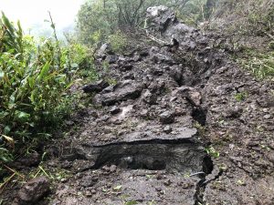 The boulders and landslide damaged the Old Pali Road causing cracking and sending concrete pieces down with the mountain.