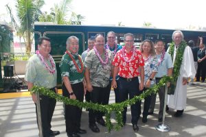 Rep. Kyle Yamashita (left to right); Governor David Ige; Sen. Rosalyn Baker (not pictured); HDOT Airports Division Deputy Director Ross Higashi; Kahului Airport Manager Marvin Moniz; Maui Mayor Mike Victorino; Senator J. Kalani English; Rep. Lynn DeCoite; Rep. Troy Hashimoto; and Kahu Kalani Wong participate in the blessing ceremony and untying of the maile lei for the new Kahului Airport Conrac.