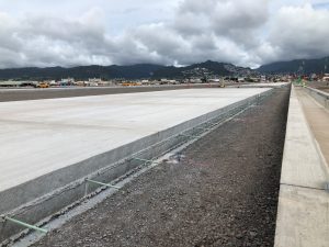 Approximately 115,000 cubic yards of concrete are being installed in the Kapalama Container Terminal project, of which 65,000 cubic yards is already complete. Photo courtesy: “HDOT” or “Hawaii Department of Transportation”